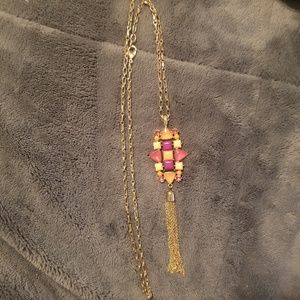 Gold tone long pendant necklace with tassle